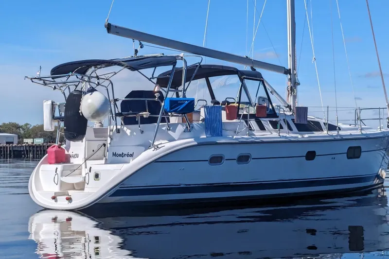 Slide: The Image of Hunter 410 sailboat from 2002 docked on calm water, featuring a sleek design. - 36