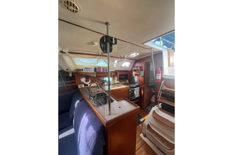 Slide: The Image of Interior of 2002 Hunter 410 sailboat with kitchen and seating area. - 8