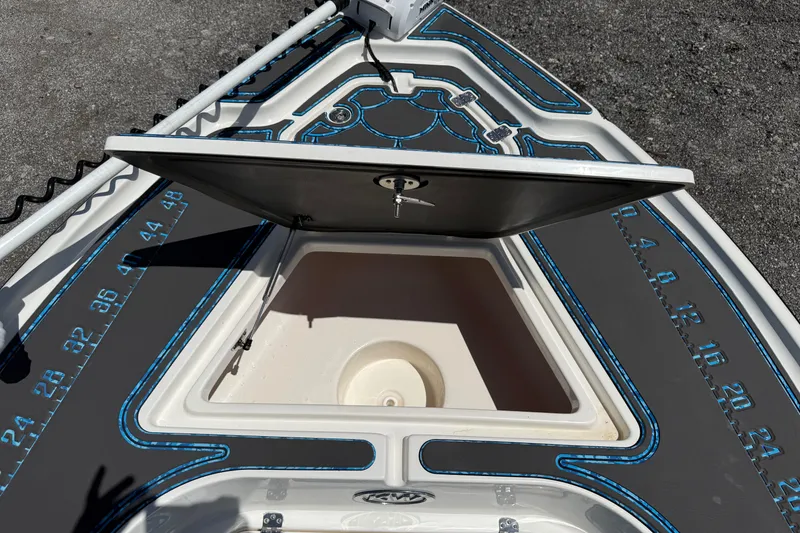 Slide: The Image of 2023 Key West 188 Bay Reef boat with open storage compartment and detailed deck design. - 11