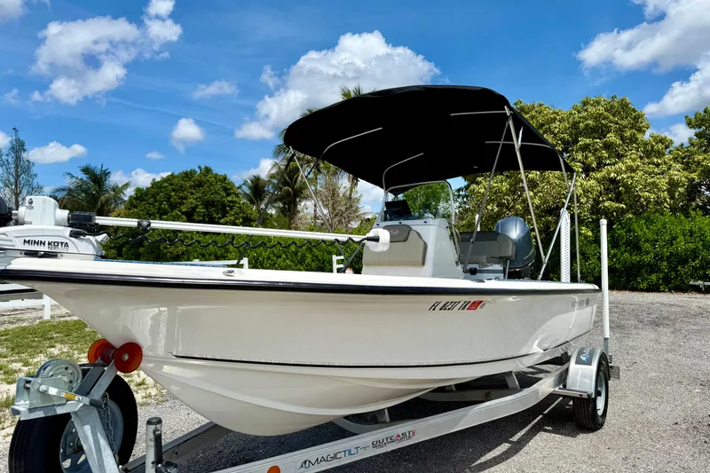 Slide: The Image of 2023 Key West 188 Bay Reef boat on trailer under blue sky. - 2