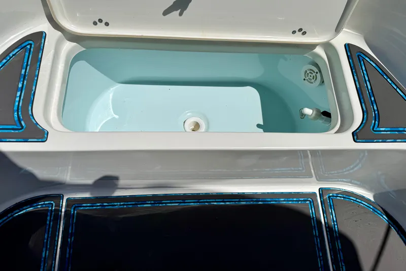 Slide: The Image of Livewell compartment on 2023 Key West 188 Bay Reef boat, featuring blue accents and drainage system. - 24