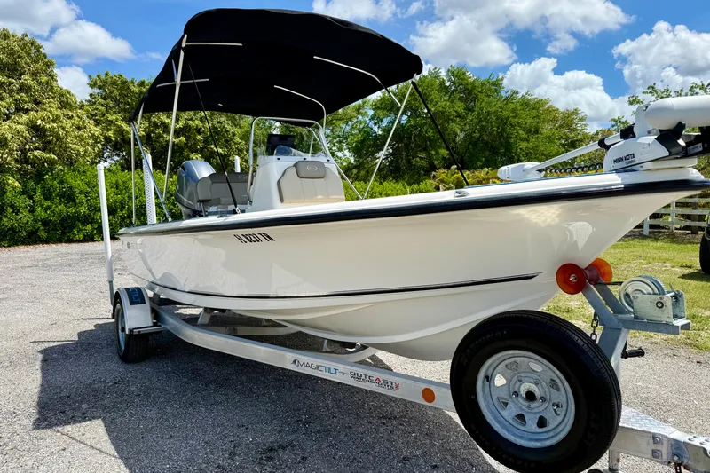 Slide: The Image of 2023 Key West 188 Bay Reef boat on trailer, featuring a sleek design and canopy. - 3
