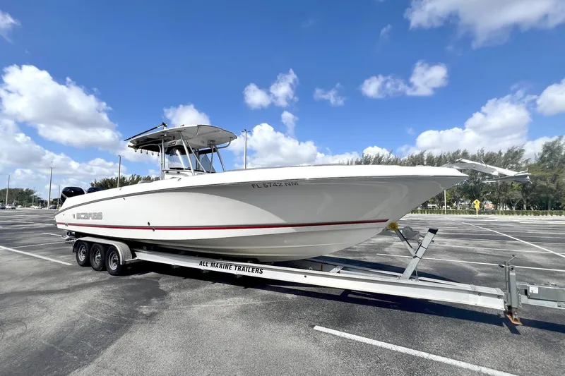 The Image of 2007 Wellcraft 35 Scarab Sport Open boat on trailer under blue sky. - 0