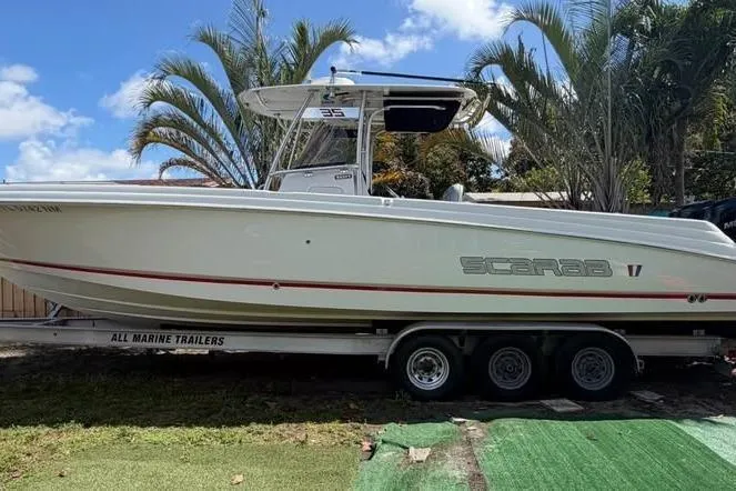 Slide: The Image of 2007 Wellcraft 35 Scarab Sport Open boat on trailer under blue sky. - 2