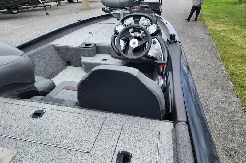 Slide: The Image of 2024 Tracker Pro Team 175 TXW boat interior with steering wheel and seating. - 3