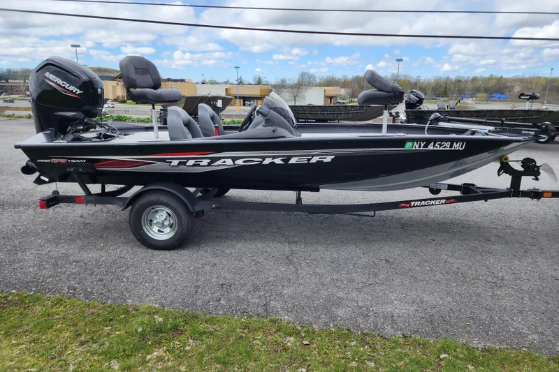 Slide: The Image of 2024 Tracker Pro Team 175 TXW fishing boat on trailer, parked outdoors. - 4