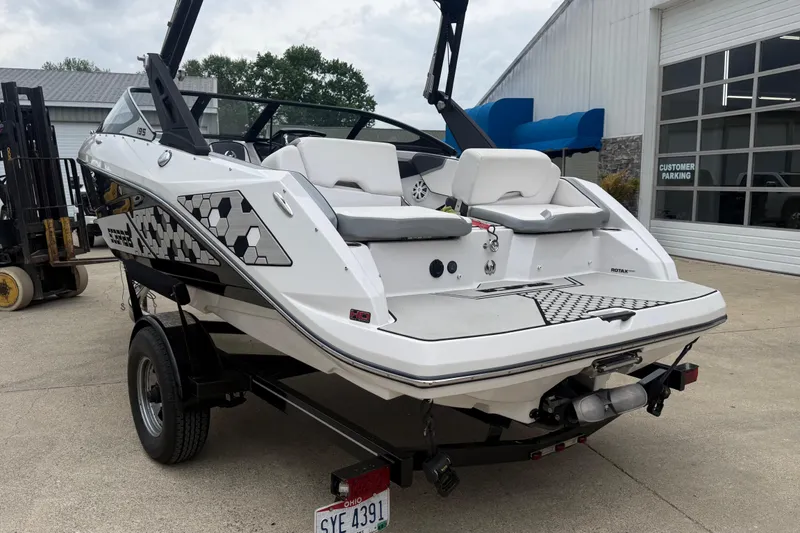 Slide: The Image of 2017 Scarab 195 H.O. boat on trailer, parked outside a building. - 3