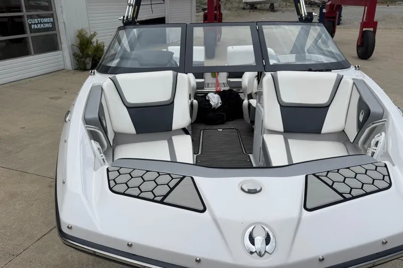 Slide: The Image of 2017 Scarab 195 H.O. boat with sleek white and gray interior, parked outdoors. - 6