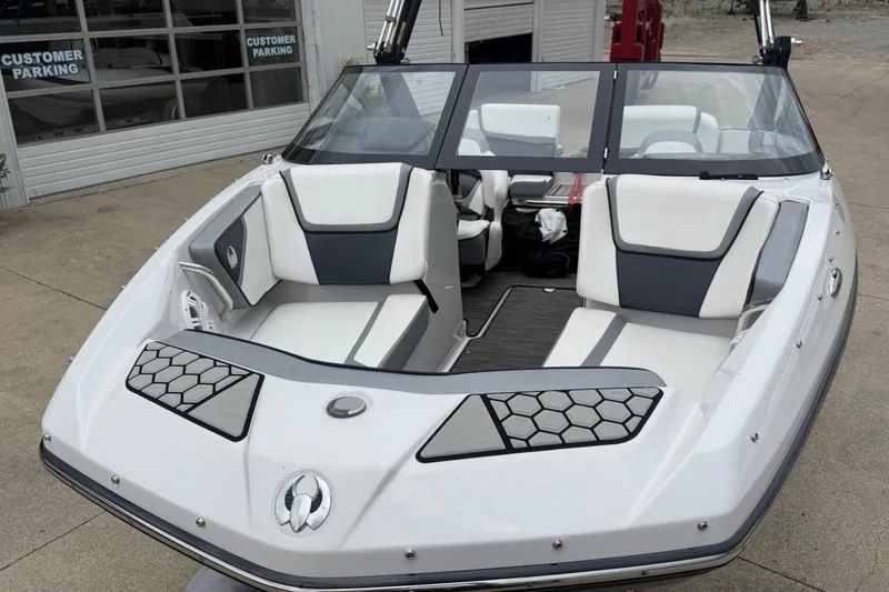 Slide: The Image of 2017 Scarab 195 H.O. boat with sleek design and comfortable seating in a parking area. - 7