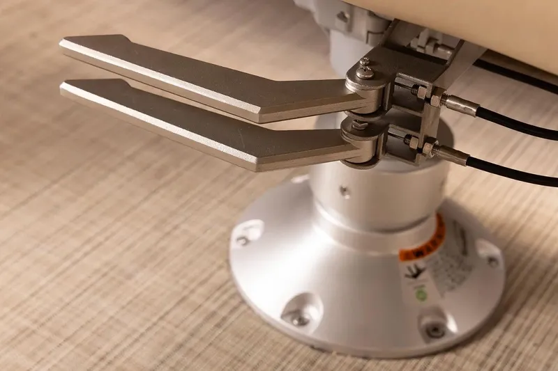 Slide: The Image of Close-up of SunCatcher Elite 322SR 2026 boat seat mechanism on wooden floor. - 14