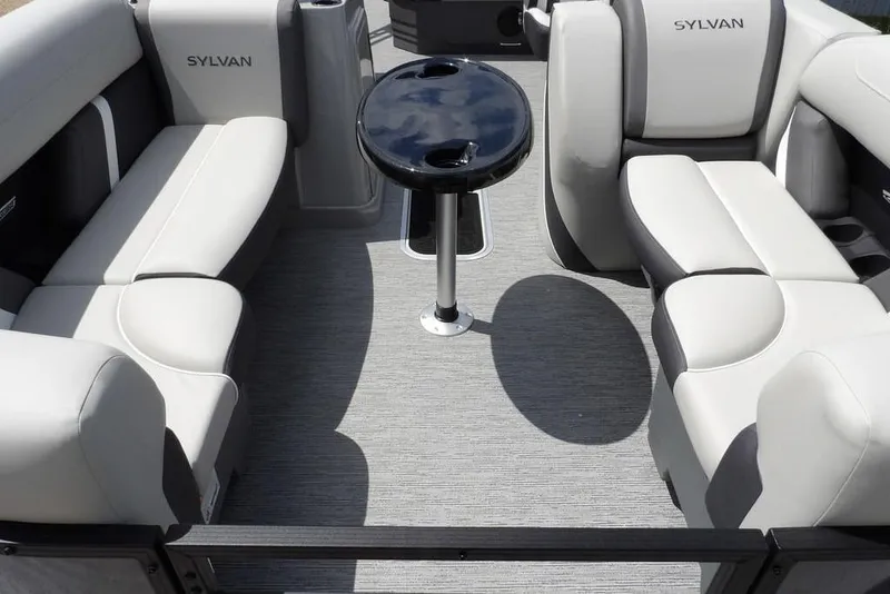 Slide: The Image of 2026 Sylvan X3 CLZ DH boat interior with plush seating and central table. - 12