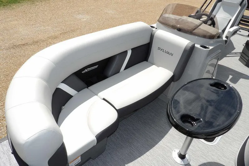 Slide: The Image of Luxurious seating on 2026 Sylvan X3 CLZ DH pontoon boat with sleek design and table. - 14