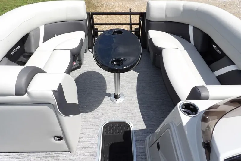 Slide: The Image of Luxurious seating area on 2026 Sylvan X3 CLZ DH pontoon boat with sleek black table. - 18