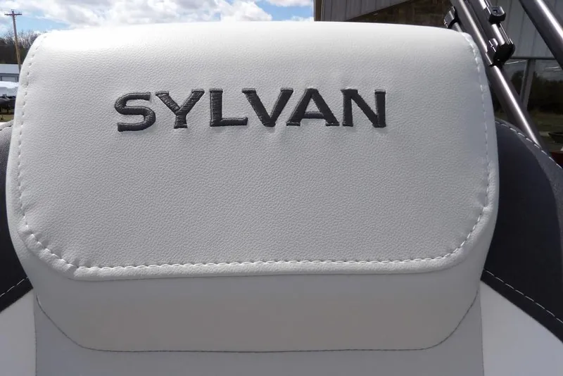 Slide: The Image of White Sylvan X3 CLZ DH 2026 boat seat with logo, outdoor setting. - 33