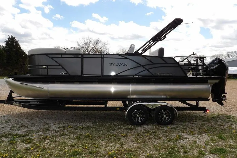 Slide: The Image of 2026 Sylvan X3 CLZ DH pontoon boat on trailer, side view, outdoors. - 8