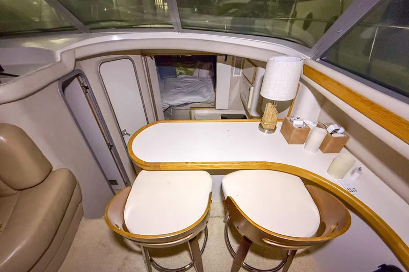 Slide: The Image of Interior of 1995 Sea Ray 370 Sedan Bridge with dining area and seating. - 13
