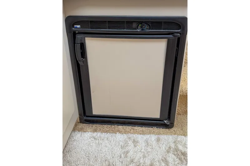 Slide: The Image of Compact refrigerator in a 1995 Sea Ray 370 Sedan Bridge yacht interior. - 17