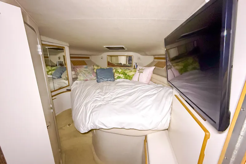 Slide: The Image of Interior cabin of 1995 Sea Ray 370 Sedan Bridge with bed and TV. - 17