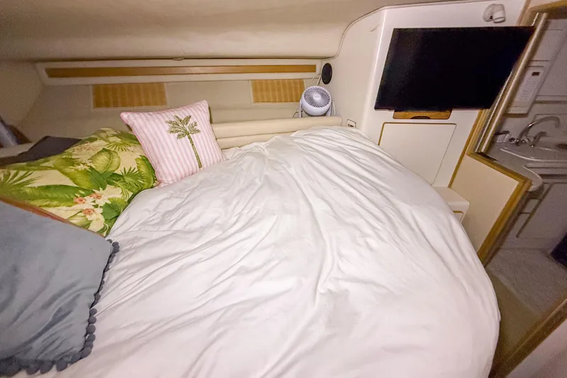 Slide: The Image of Cozy cabin interior of 1995 Sea Ray 370 Sedan Bridge with bed and TV. - 18