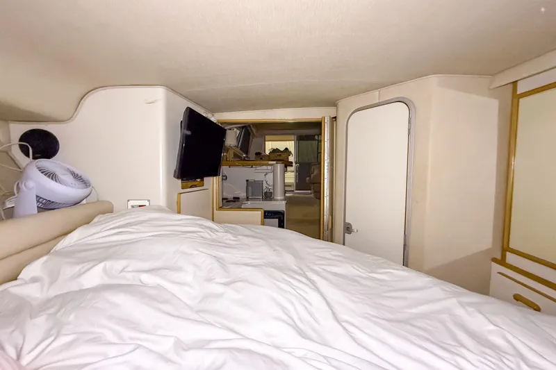 Slide: The Image of Interior cabin of a 1995 Sea Ray 370 Sedan Bridge with bed and TV. - 19