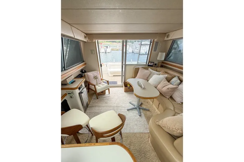 Slide: The Image of Interior of 1995 Sea Ray 370 Sedan Bridge, featuring cozy seating and elegant decor. - 13