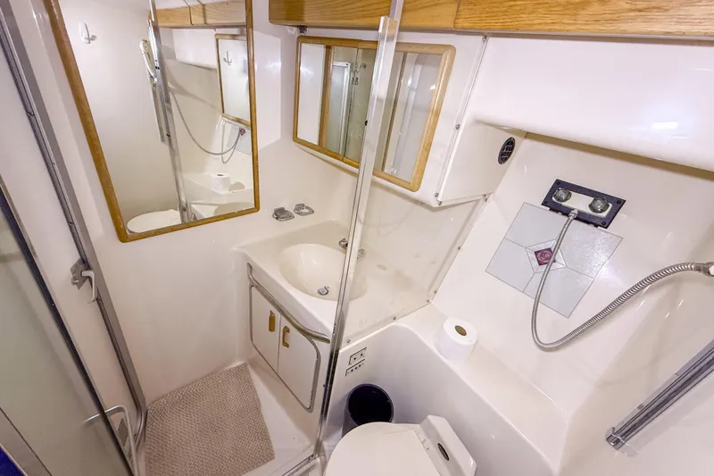Slide: The Image of Bathroom interior of 1995 Sea Ray 370 Sedan Bridge yacht, featuring sink and shower. - 22