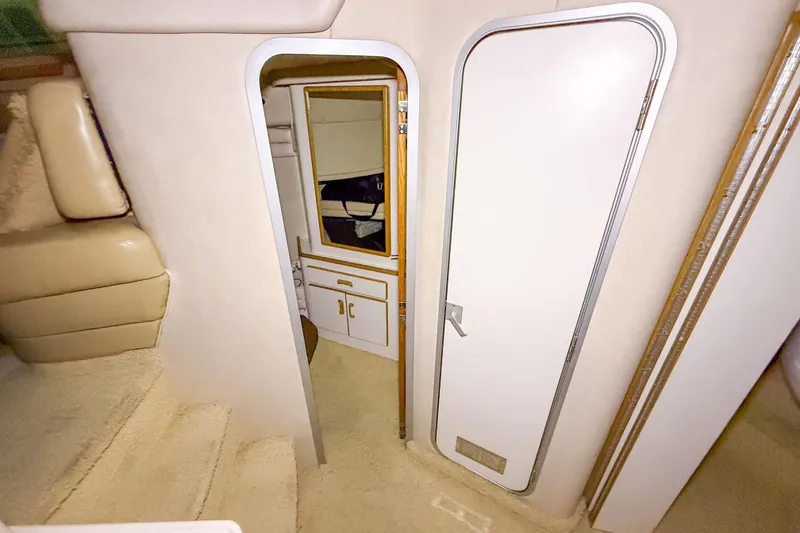 Slide: The Image of Interior of 1995 Sea Ray 370 Sedan Bridge, featuring cabin door and seating area. - 23