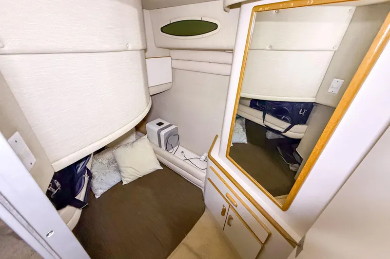 Slide: The Image of Interior cabin of 1995 Sea Ray 370 Sedan Bridge with mirror and cozy seating area. - 24