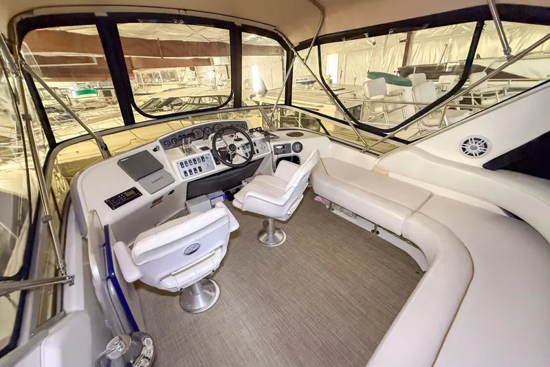 Slide: The Image of Interior of 1995 Sea Ray 370 Sedan Bridge yacht with helm and seating area. - 26