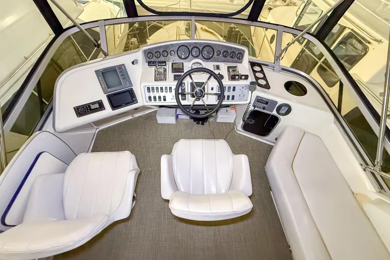 Slide: The Image of Cockpit of 1995 Sea Ray 370 Sedan Bridge with steering wheel and control panel. - 27