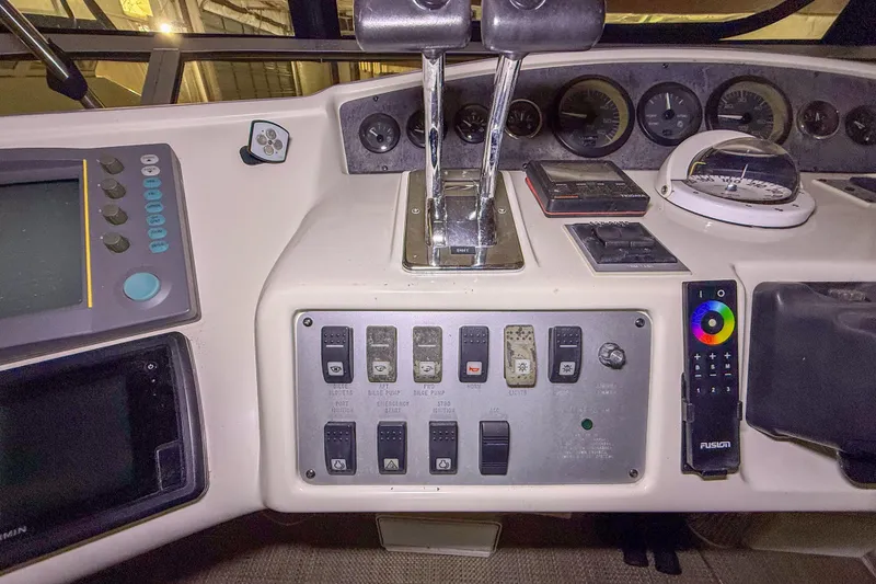Slide: The Image of Control panel of a 1995 Sea Ray 370 Sedan Bridge with gauges and switches. - 31