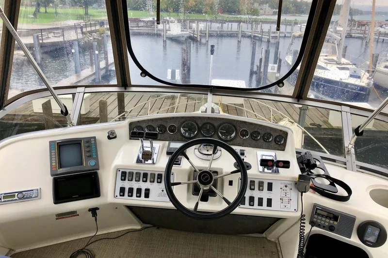 Slide: The Image of 1995 Sea Ray 370 Sedan Bridge interior with seating, ladder, and sliding door. - 4