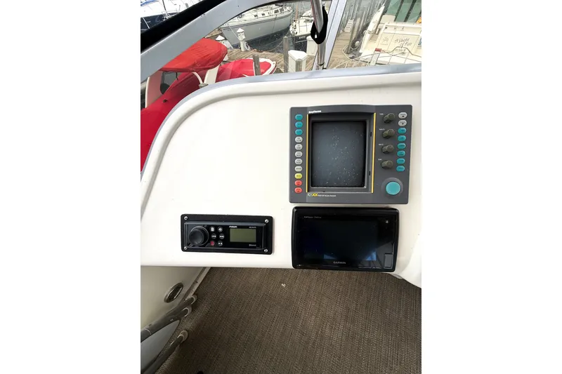 Slide: The Image of 1995 Sea Ray 370 Sedan Bridge helm with navigation equipment and control panel. - 31
