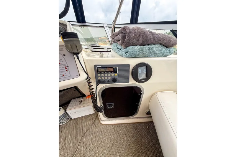 Slide: The Image of 1995 Sea Ray 370 Sedan Bridge helm with radio, towels, and control panel. - 32
