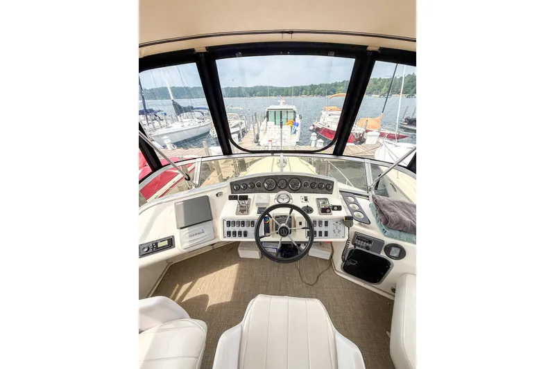 Slide: The Image of 1995 Sea Ray 370 Sedan Bridge helm with panoramic marina view. - 29