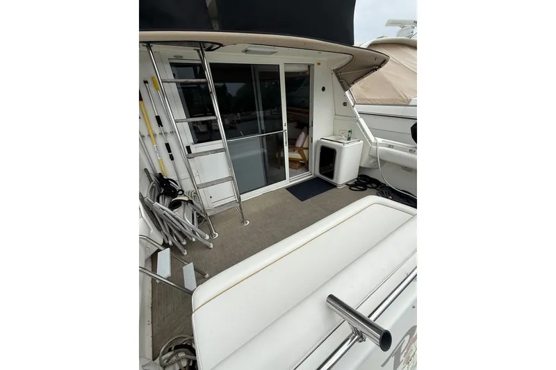 Slide: The Image of 1995 Sea Ray 370 Sedan Bridge yacht deck with seating and ladder. - 7