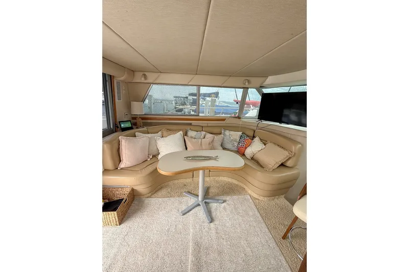 Slide: The Image of Interior of 1995 Sea Ray 370 Sedan Bridge with cozy seating and decor. - 10
