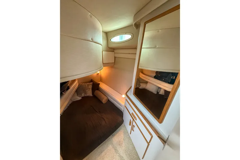 Slide: The Image of Cozy interior cabin of 1995 Sea Ray 370 Sedan Bridge with mirror and cushions. - 20