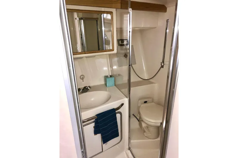 Slide: The Image of Bathroom interior of 1996 Sea Ray 370 Sedan Bridge yacht, featuring sink and toilet. - 10