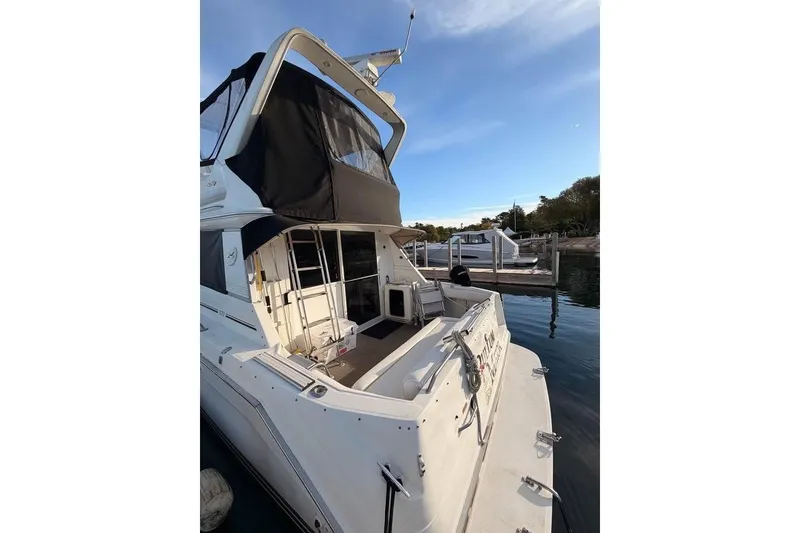 Slide: The Image of 1996 Sea Ray 370 Sedan Bridge yacht docked at marina, rear view. - 3