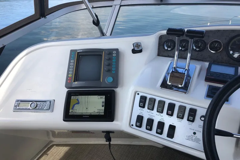 Slide: The Image of 1996 Sea Ray 370 Sedan Bridge helm with navigation equipment and control panel. - 5