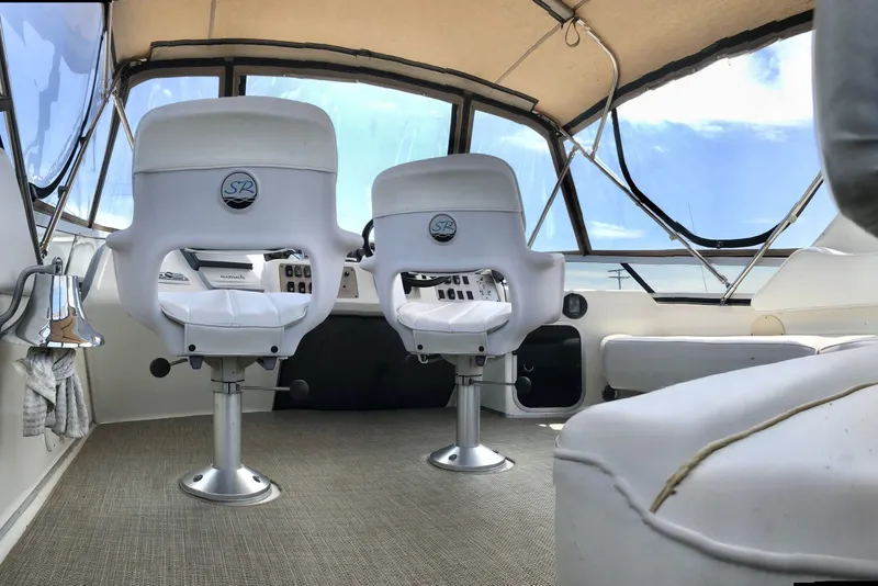 Slide: The Image of Interior of 1996 Sea Ray 370 Sedan Bridge with helm chairs and panoramic windows. - 6