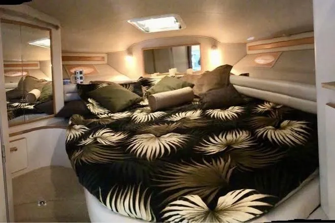 Slide: The Image of Luxurious cabin interior of 1996 Sea Ray 370 Sedan Bridge with tropical bedding. - 9