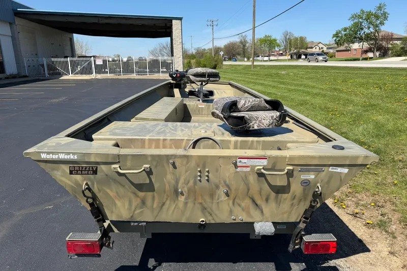 Slide: The Image of 2008 Tracker Grizzly 1648 T Blind Duck Edition boat with camo design, parked outdoors. - 2