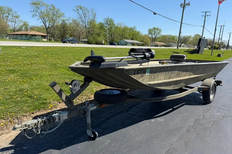Slide: The Image of 2008 Tracker Grizzly 1648 T Blind Duck Edition boat on trailer, parked outdoors. - 4