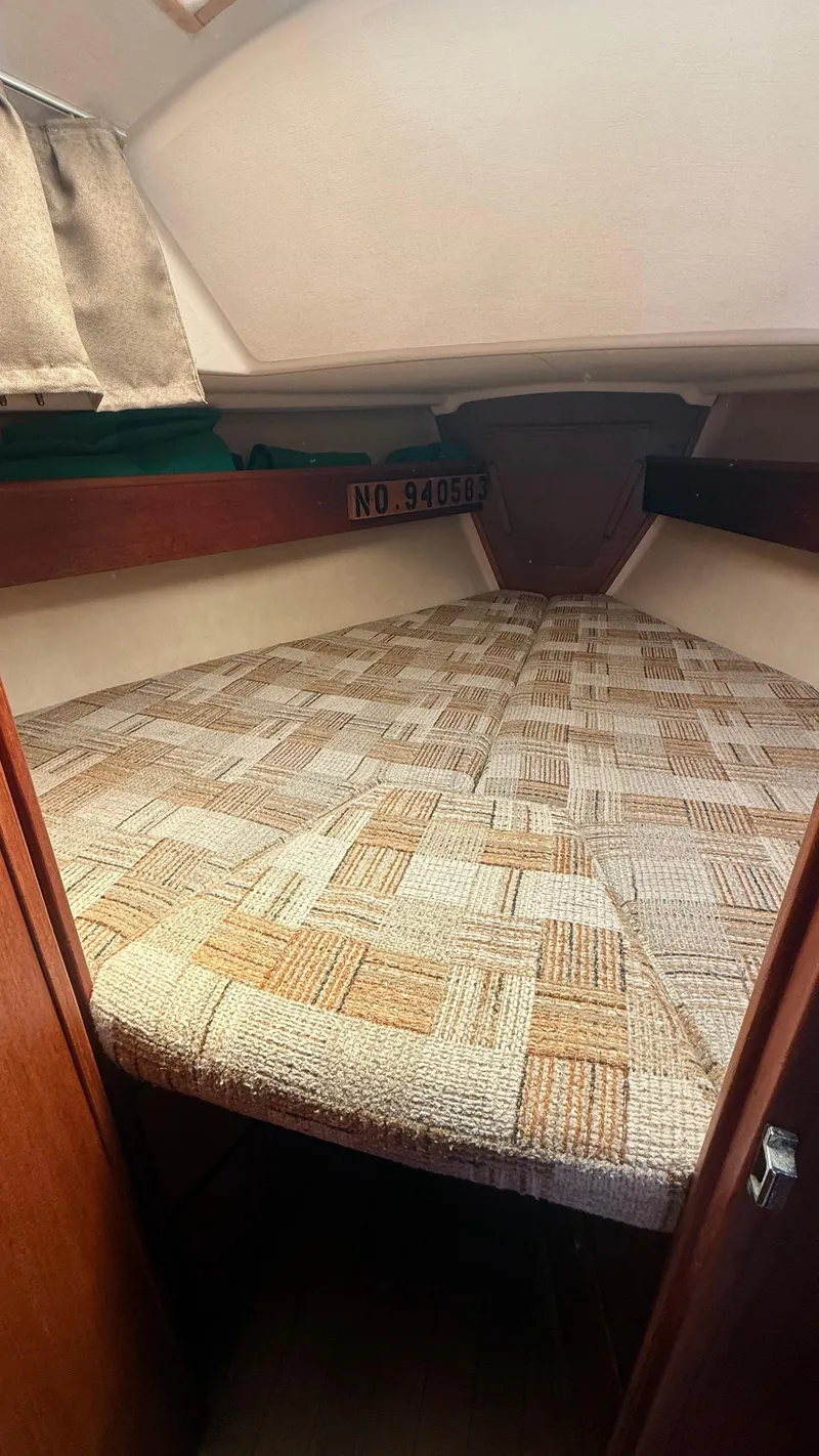 Slide: The Image of Interior cabin of 1981 Sabre 28 sailboat with patterned bedding. - 10
