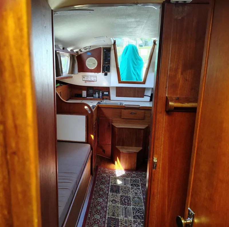 Slide: The Image of Interior of a 1981 Sabre 28 sailboat with wood finish and cozy cabin layout. - 15