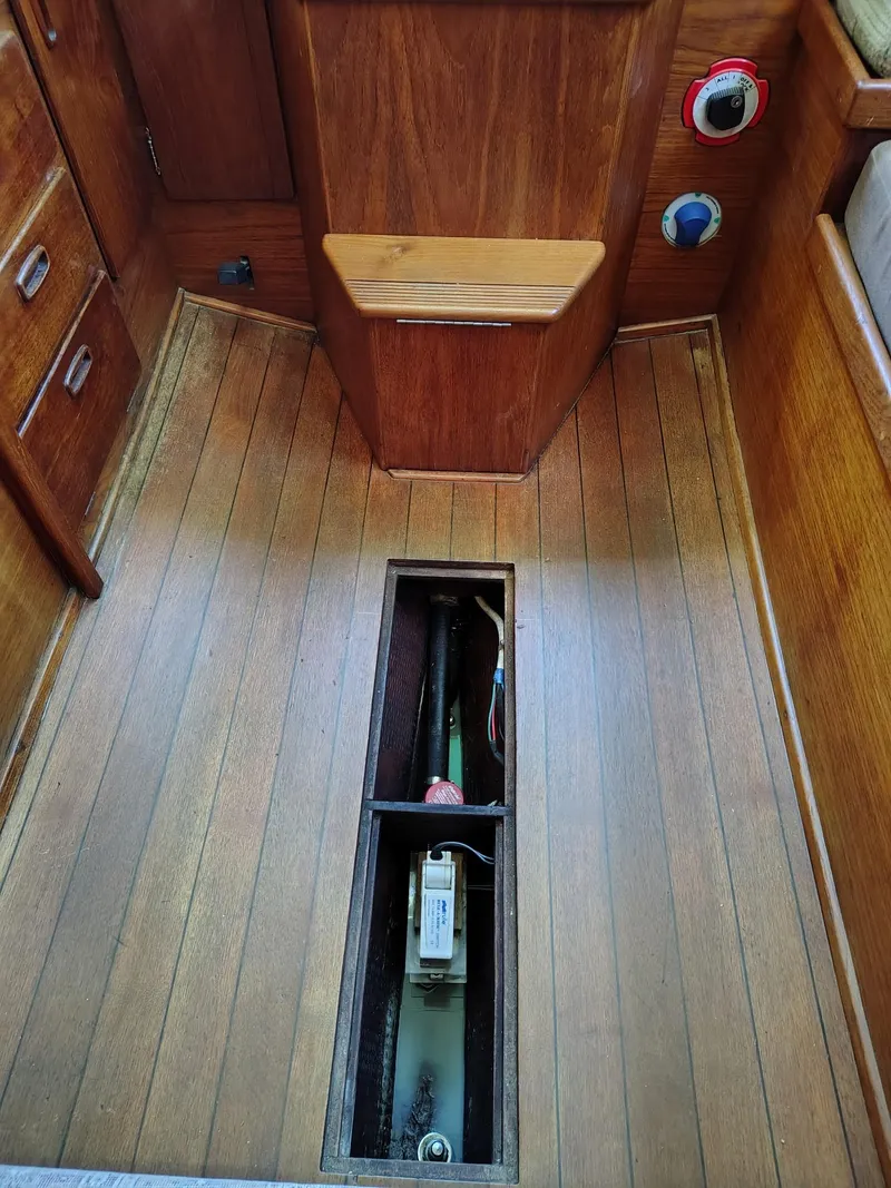 Slide: The Image of 1981 Sabre 28 sailboat interior with open floor panel revealing mechanical components. - 17