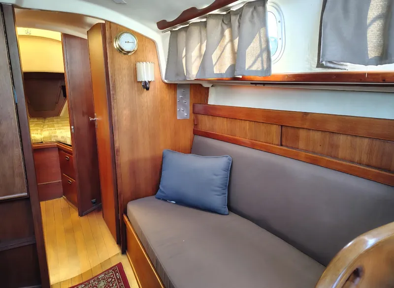Slide: The Image of Interior of 1981 Sabre 28 sailboat with wooden finish and cozy seating area. - 2