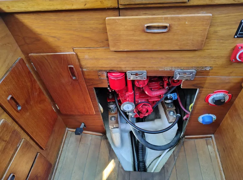 Slide: The Image of Engine compartment of a 1981 Sabre 28 sailboat with visible red engine components. - 20
